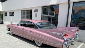 A pink vintage car parked in front of a building with a sign that reads "Motel". - Motel Eldorado (Mikulov)