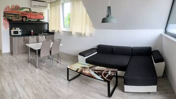 Cadillac Apartment | Living area | 102-cm LCD TV with digital channels, TV