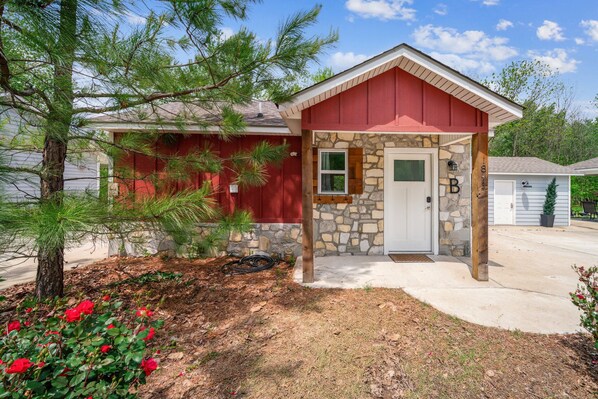 A single-story house with a stone foundation and a red exterior.