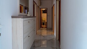 A hallway with a wooden dresser, a mirror, and a door leading to a bathroom. - Apartments Peselj-Three Bedroom Apartment with Terrace and Sea View (Smokvica)