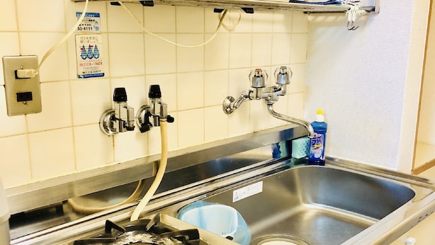 A kitchen with a gas stove, a sink, and a microwave. - Ichijyo-IVY Bunk bed twin (Kyoto)
