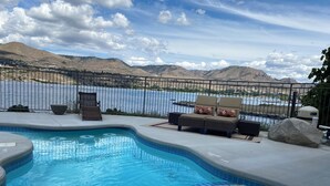 A swimming pool with a view of mountains and a lake. - Floating Over The Water! (Chelan)