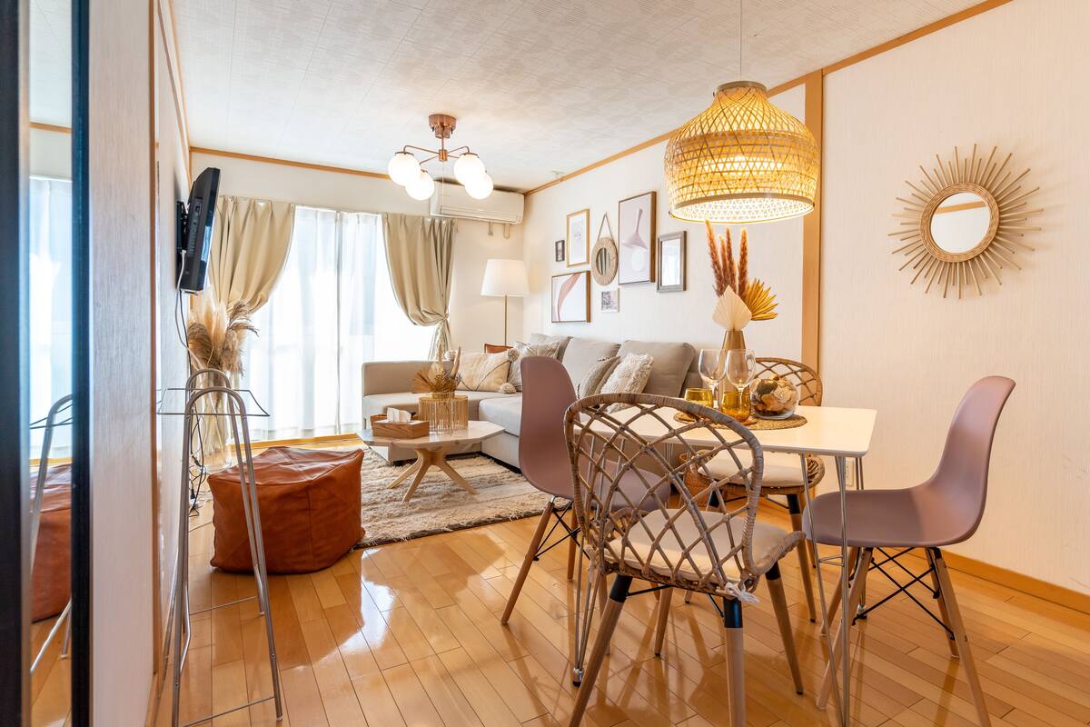 A modern living room with a sofa, coffee table, and dining area.