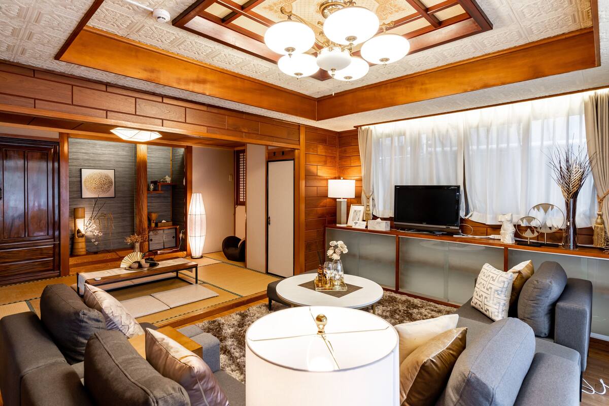 A modern living room with a sofa set, a coffee table, and a television.