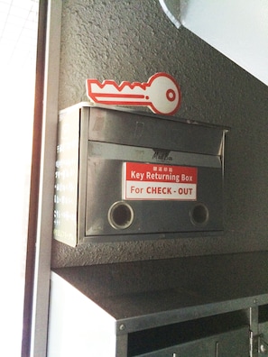 A key returning box labeled "Key Returning Box For CHECK-OUT" on a wall. - Gojyo-IVY Semi-double bed 1 (Kyoto)