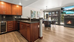 A modern kitchen with wooden cabinets, a granite countertop, and a built-in dishwasher.