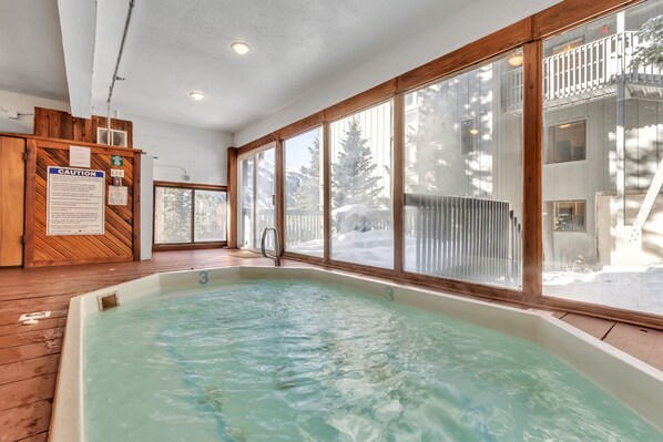 A large indoor swimming pool with wooden flooring and large windows. - Mountain Summit Getaway - within minutes of Alta and Snowbird (Alta)