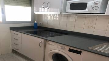 Frigorífico, microondas, cafetera o tetera y utensilios de cocina