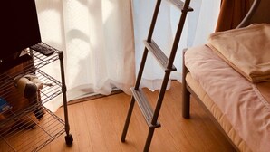 A bunk bed with a ladder, a desk with a computer, and a window with curtains. - Nishijin-IVY Bunk bed twin (Kyoto)