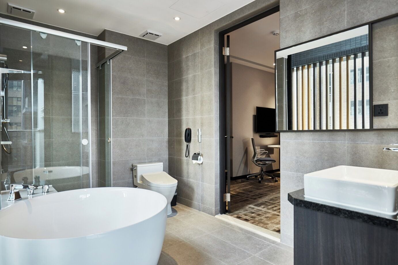 corner studio (pool view) | bathroom | free toiletries, hair dryer, slippers, bidet