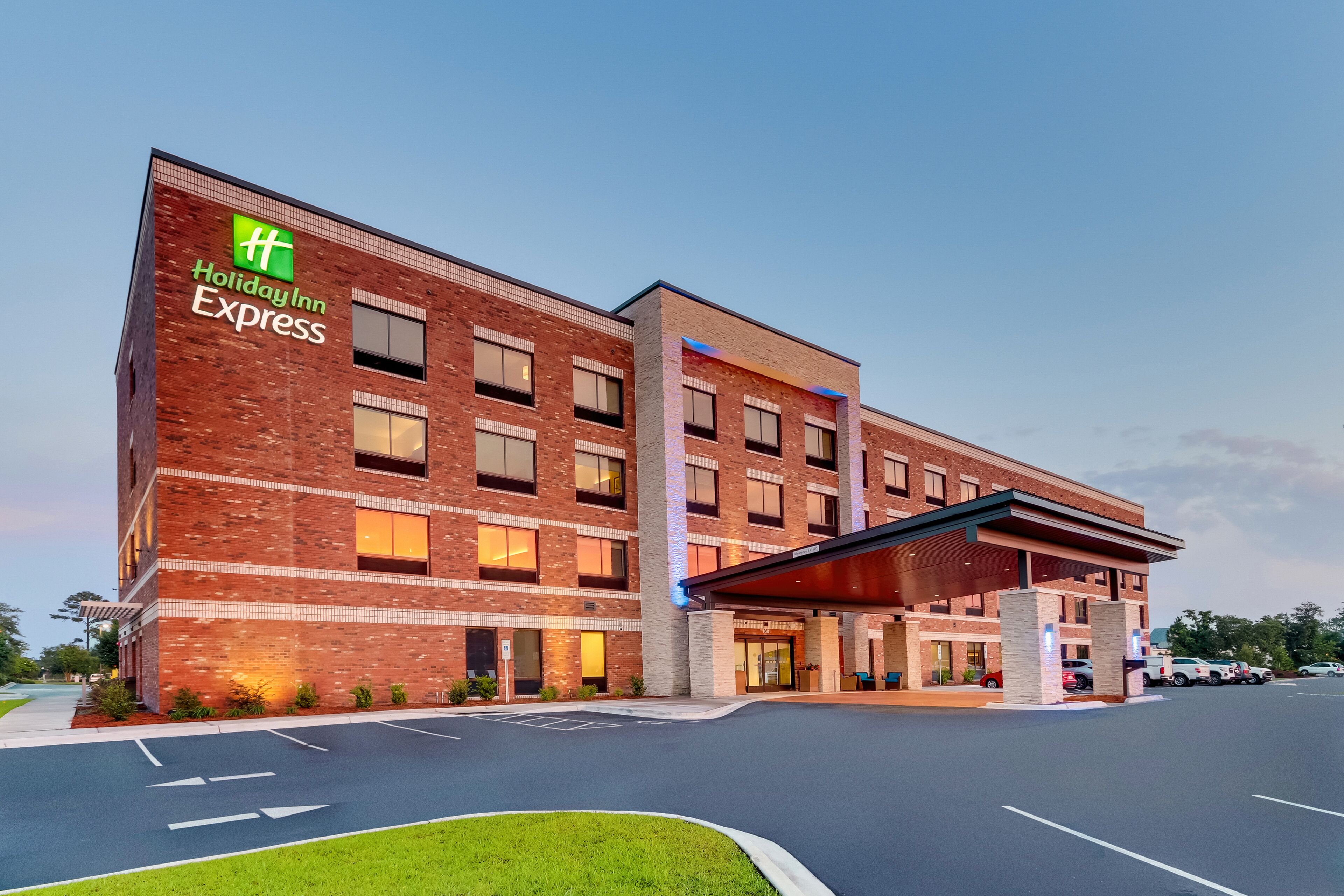 A Holiday Inn Express building with a brick facade, multiple windows, and a covered entrance.