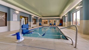 An indoor swimming pool with a lifeguard chair, poolside chairs, and a no diving sign. - Holiday Inn Express Wilmington Porters Neck by IHG (Wilmington)