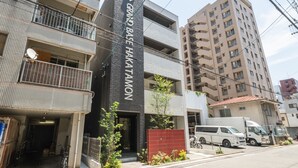 A multi-story building with a prominent sign reading "GRAND BASE HAKATAMON". - GRAND BASE Hakatamon (Fukuoka)