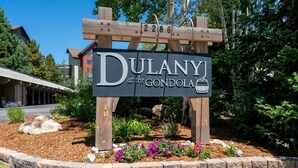A sign for 'Dulany at the Gondola' with a stone border and a wooden structure.