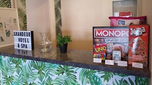 A hotel reception desk with a sign reading "GRANDEUR HOTEL & SPA". - Grandeur Hotel and Spa (Malacca City)