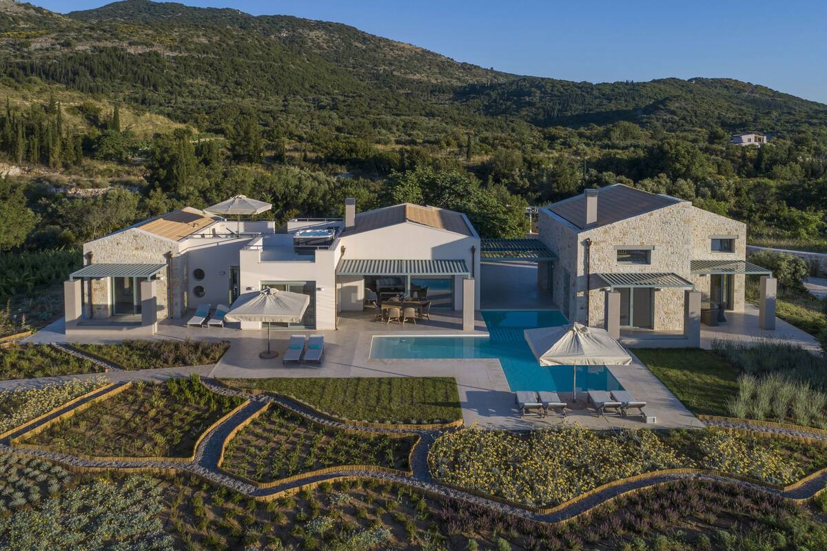 A modern villa with a swimming pool, outdoor seating, and a landscaped garden.