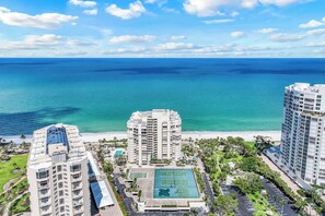 A high-rise hotel with a tennis court and a pool, overlooking a beach and ocean. - La Mer at Park Shore (Naples)