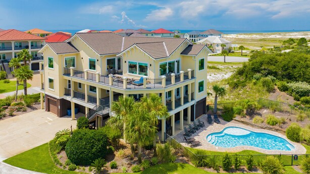 A multi-story hotel with a pool and a view of the beach. - Waterfront | Private Pool | Pet-Friendly | Boat Slip (Gulf Shores)