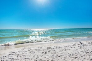 A beach with clear skies and calm waters. - Venus 111 is a Ground Floor 2 BR on Okaloosa Island steps from the pool by RedAwning (Fort Walton Beach)