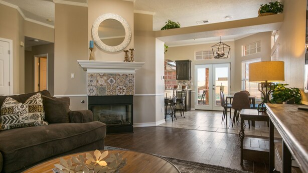 A spacious living room with a fireplace, a dining area, and a kitchen visible through an open door. - Hot tub with city views 
     -NO PARTIES ALLOWED- (Albuquerque)