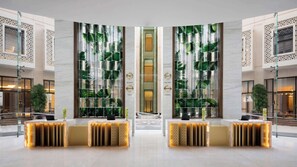 A spacious lobby with a central reception desk, mirrored walls, and a modern design. - Grand Hyatt Alkhobar Hotel and Residences (Al Khobar)