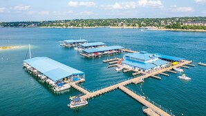 An aerial view of a marina with multiple docks and covered structures. - Incredible waterfront! Relaxing!- Swim & Fish, Pool Access (Point Venture)