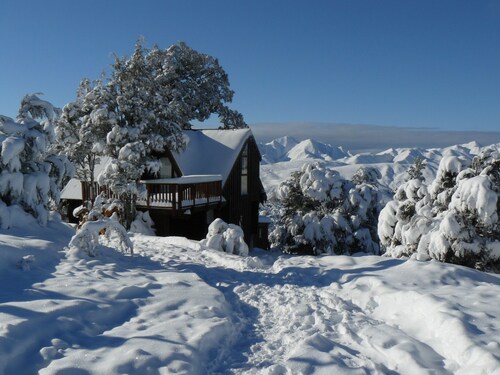 Log cabin in the mountains with indoor climbing wall, perfect for a family.
