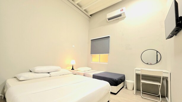 A hotel room with a large bed, a desk with a chair, a TV, a mirror, and an air conditioning unit. - No33 Mandalay House near Gleneagles Island Northern Heart Loh Guan Lye Hospital (George Town)