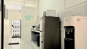 A modern kitchen with a refrigerator, a water dispenser, and a sink. - No33 Mandalay House near Gleneagles Island Northern Heart Loh Guan Lye Hospital (George Town)