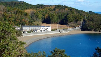 Overlooking serene waters, this coastal hotel offers stunning views of lush green hills.
