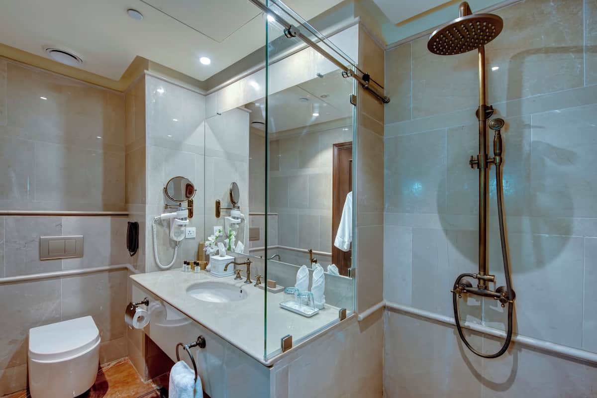 deluxe room, 1 king bed | bathroom | shower, free toiletries, hair dryer, bathrobes