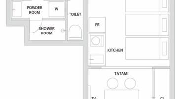 A floor plan with a powder room, shower room, toilet, kitchen, and a tatami room with a TV and a closet.