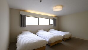 A room with three single beds, a large window with curtains, a ceiling light, and a carpeted floor. - BEYOND HOTEL Takayama 4th (Takayama)
