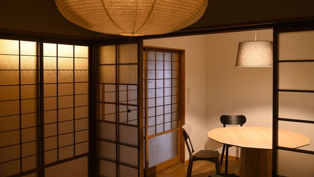 A traditional Japanese room with sliding doors, a round table, and a hanging lamp. - BEYOND HOTEL Takayama 4th (Takayama)