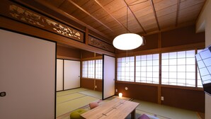 A traditional Japanese room with tatami flooring, a low wooden table, and sliding shoji doors. - BEYOND HOTEL Takayama 4th (Takayama)