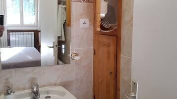 Shower, hair dryer, towels, toilet paper