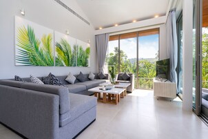 Luxury Villa | Living room | 130-cm flat-screen TV with cable channels, LED TV