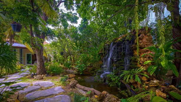 A lush garden with a waterfall, stone steps, and dense foliage. - 6BR Luxury Tropical Pool Villa PH125 (Cha-am)
