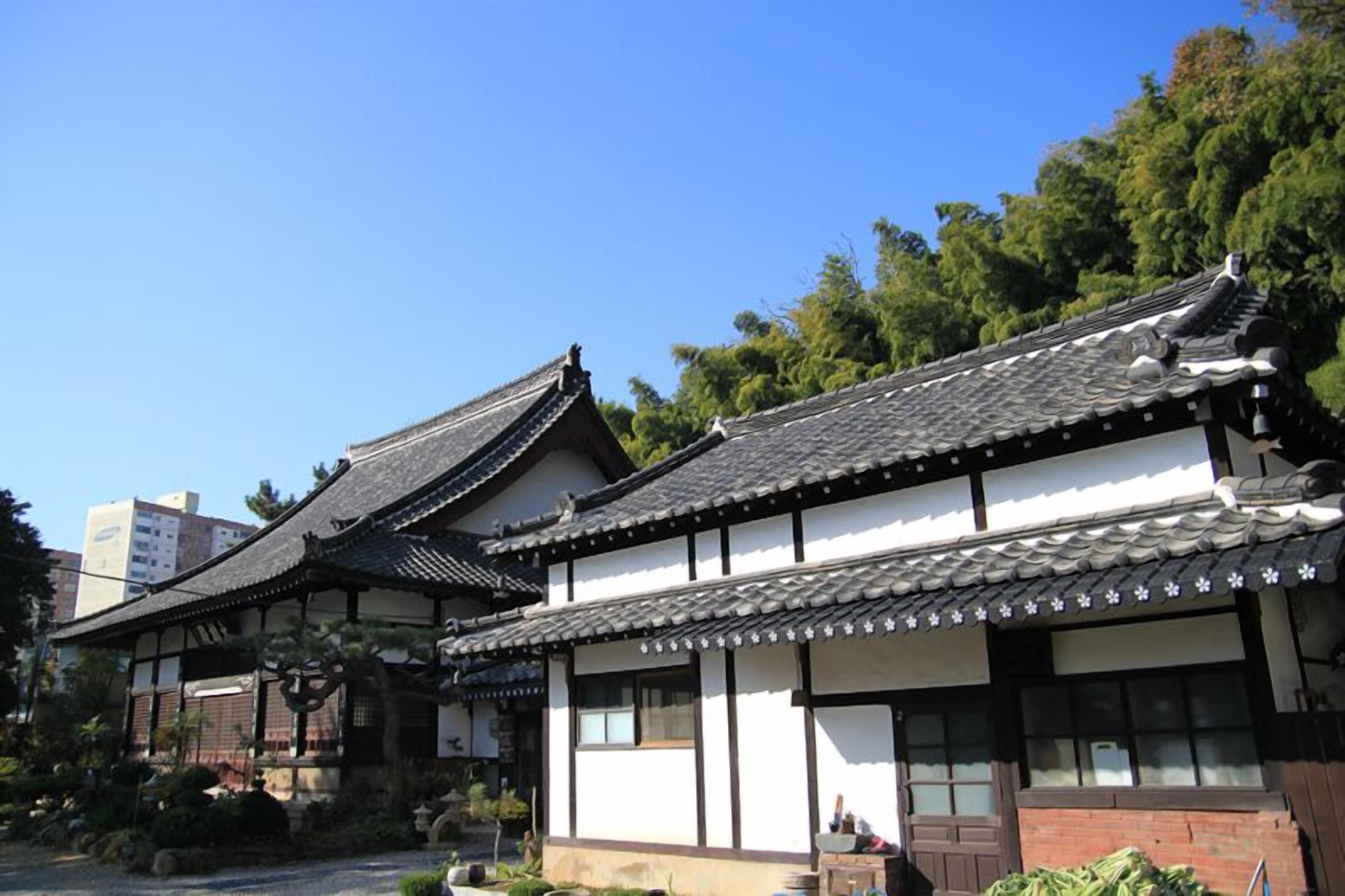 A traditional Japanese building with a tiled roof and wooden structure.