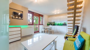 A modern living room with a white table, a yellow sofa, and a wooden ladder against the wall.