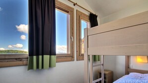 A bunk bed room with a window, curtains, and a bedside table. - Large duplex for 6/7 near slopes at Belle Plagne (Belle Plagne)