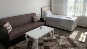 A small, neatly arranged bedroom with a single bed, a sofa, and a table. - Marida Hotel - Dargeçit (Dargeçit)