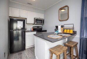 Fridge, microwave, stovetop, coffee/tea maker