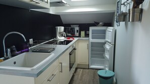 A compact kitchen with a sink, a coffee maker, a microwave, and a refrigerator. - 350m from the beach - flat for 4 (Pornichet)