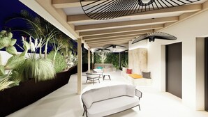 An outdoor patio with a modern design, featuring a white sofa, a dining table, and a ceiling fan. - Giafra Rooms (Agrigento)