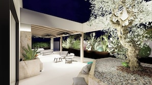 An outdoor patio with seating, a cactus tree, and a night sky. - Giafra Rooms (Agrigento)