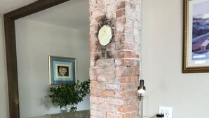 A bar area with a brick column, three cushioned bar stools, a marble countertop, and a framed picture on the wall. - Ruby`s House ~ Downtown Durango (Durango)