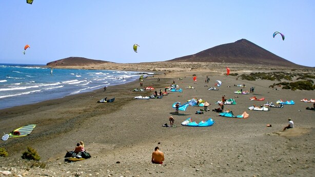 A beach with people and kites. - - (Granadilla de Abona)