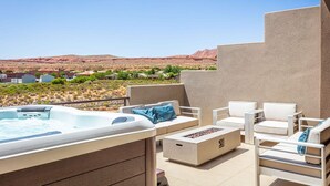 A hot tub, outdoor seating, and a view of a desert landscape. - Adventure HQ 1, Private Hot Tub! (Washington)