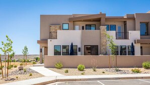 A modern multi-story residential building with a flat roof, large windows, and a stone accent wall. - Adventure HQ 1, Private Hot Tub! (Washington)